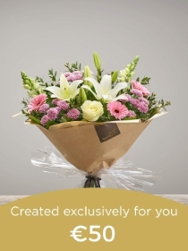 Hand tied bouquet made with seasonal flowers